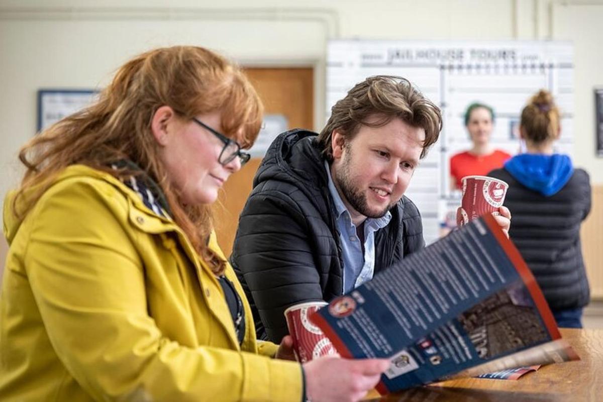 a man and a woman looking at a book