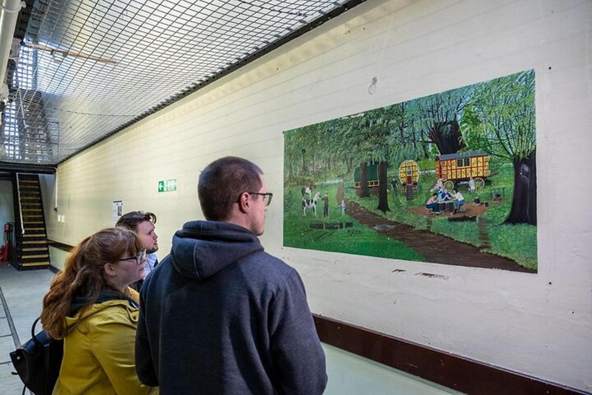 a group of people looking at a painting on a wall