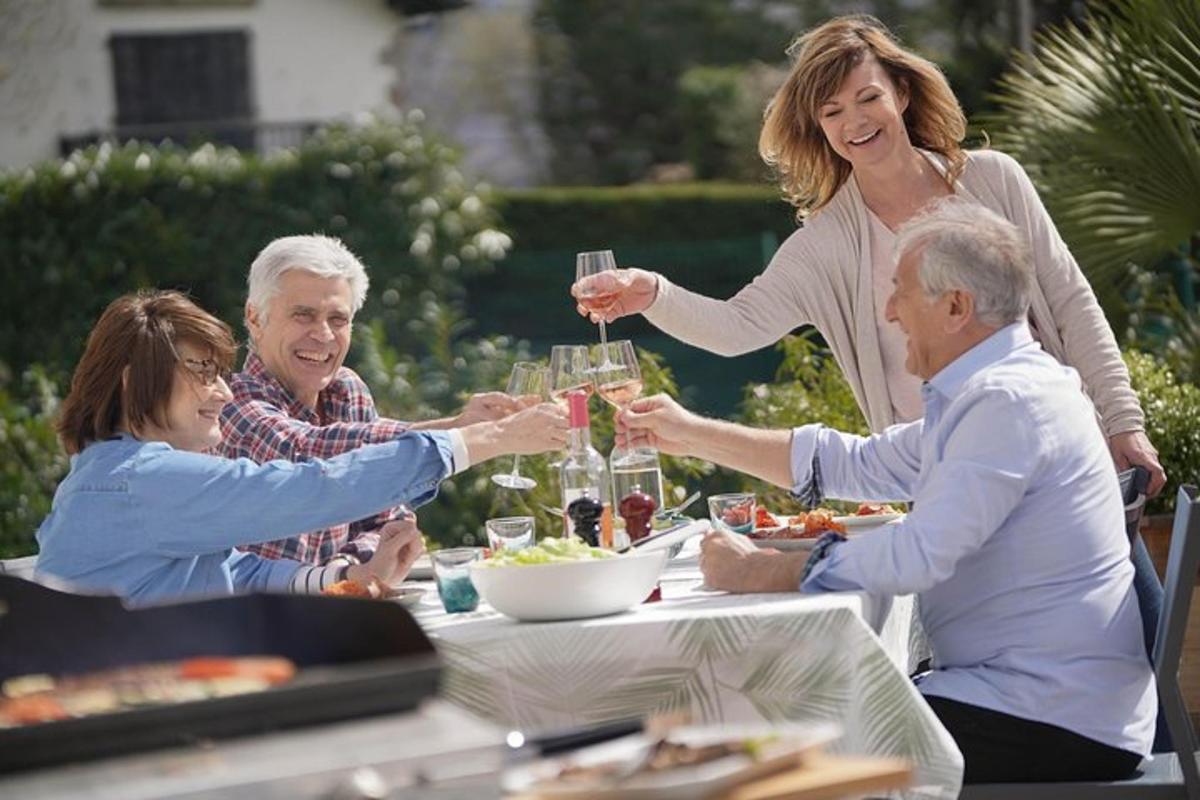 a group of people sitting around a table drinking wine