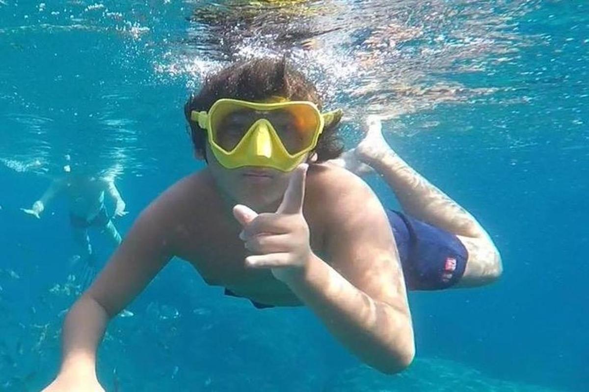 Un hombre que lleva un tubo y una máscara en el agua.