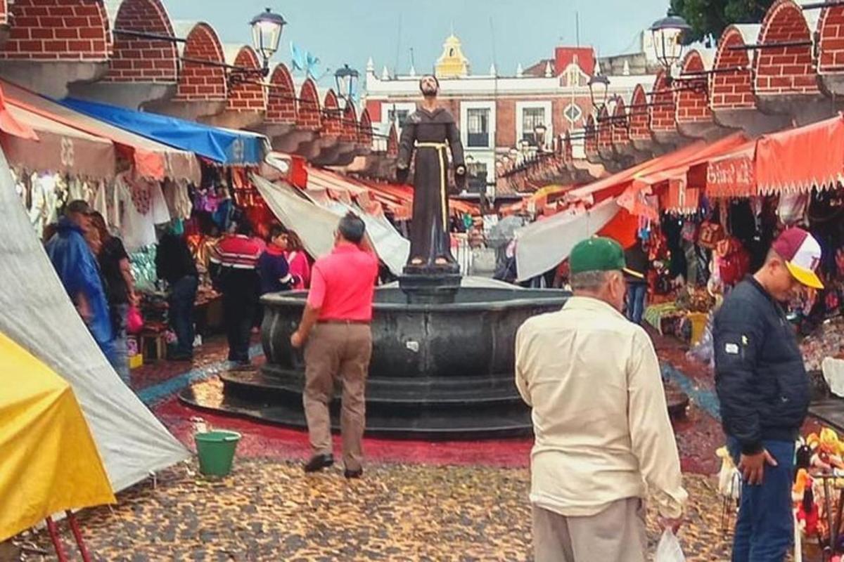 a group of people in a market with a fountain