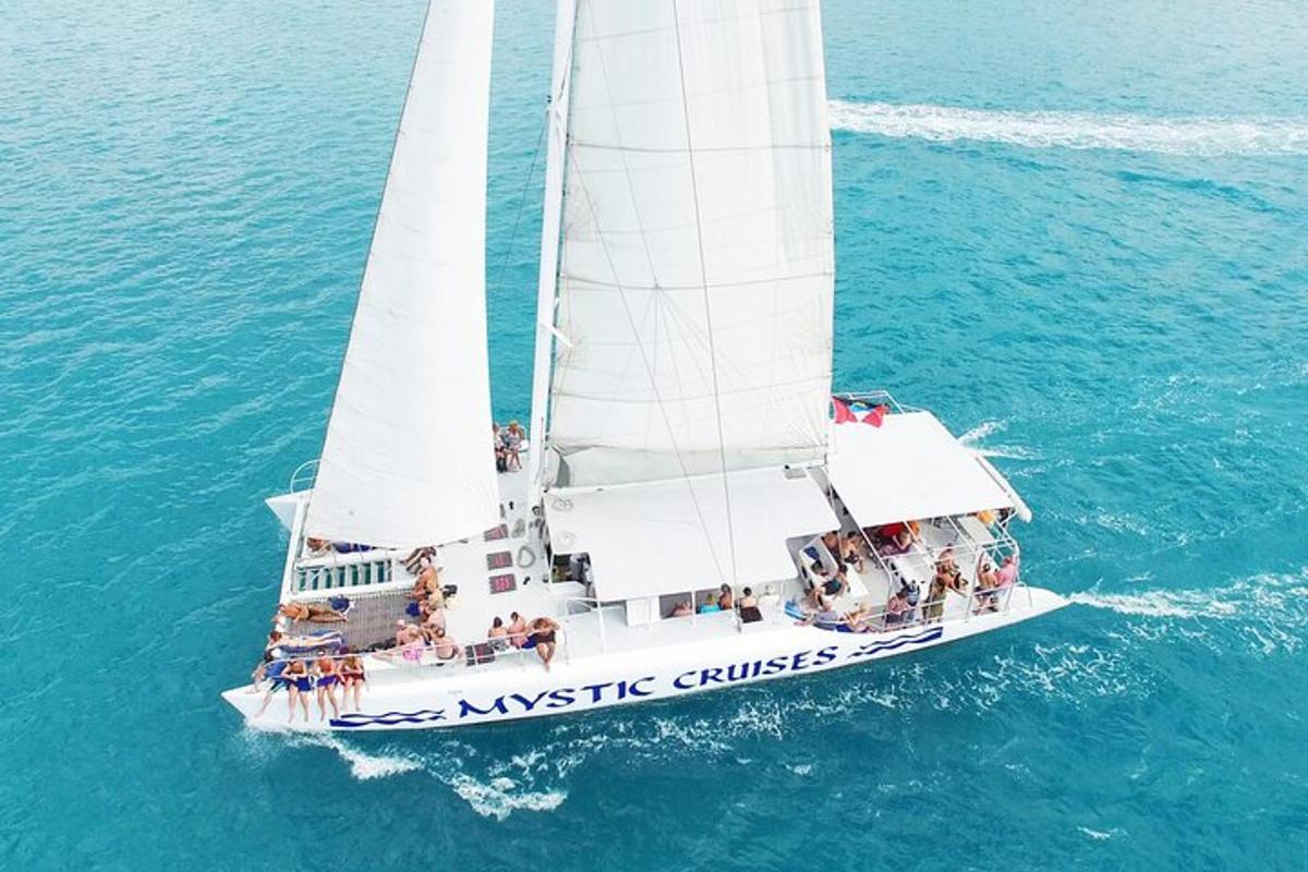 a white boat with people on it in the water