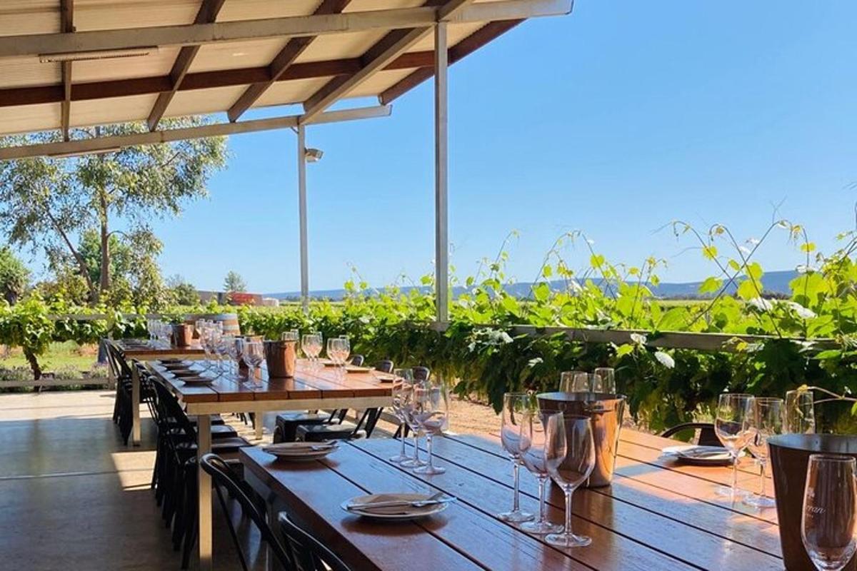 a long wooden table with wine glasses on it