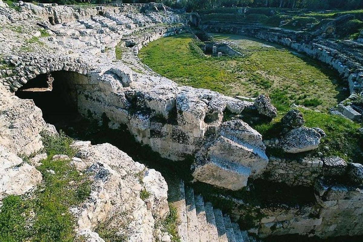 an aerial view of a stone wall with a body of water