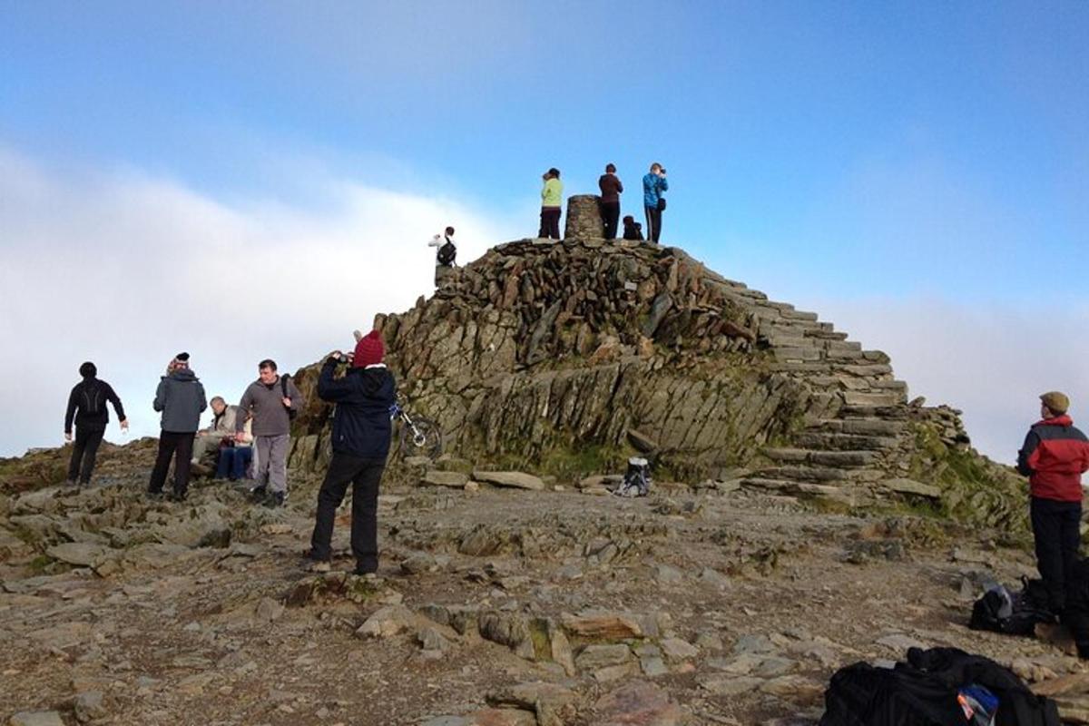a group of people standing on top of a mountain