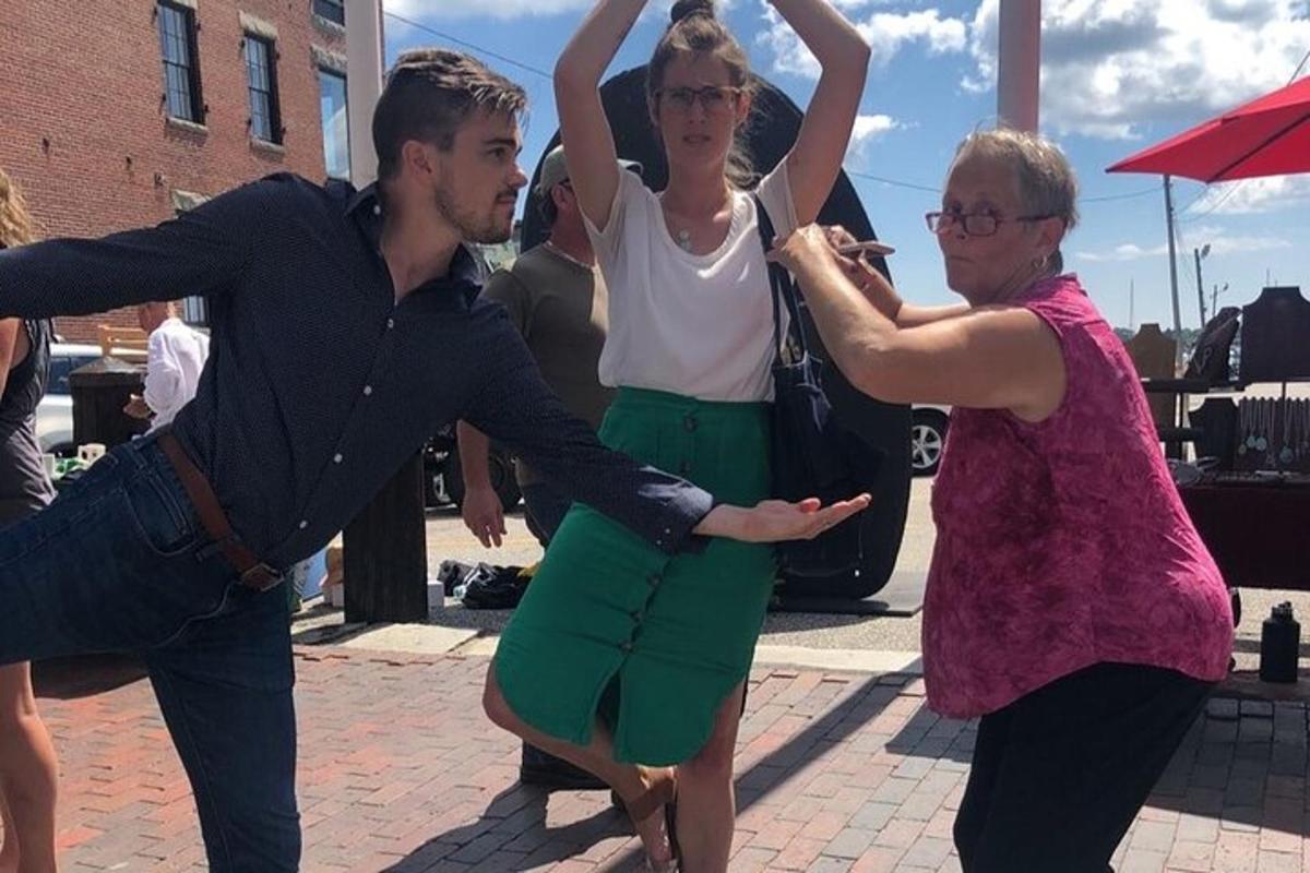 a group of people dancing on a street