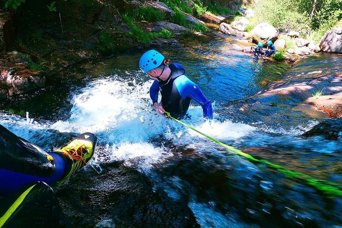 a person on a rope in the water on a river