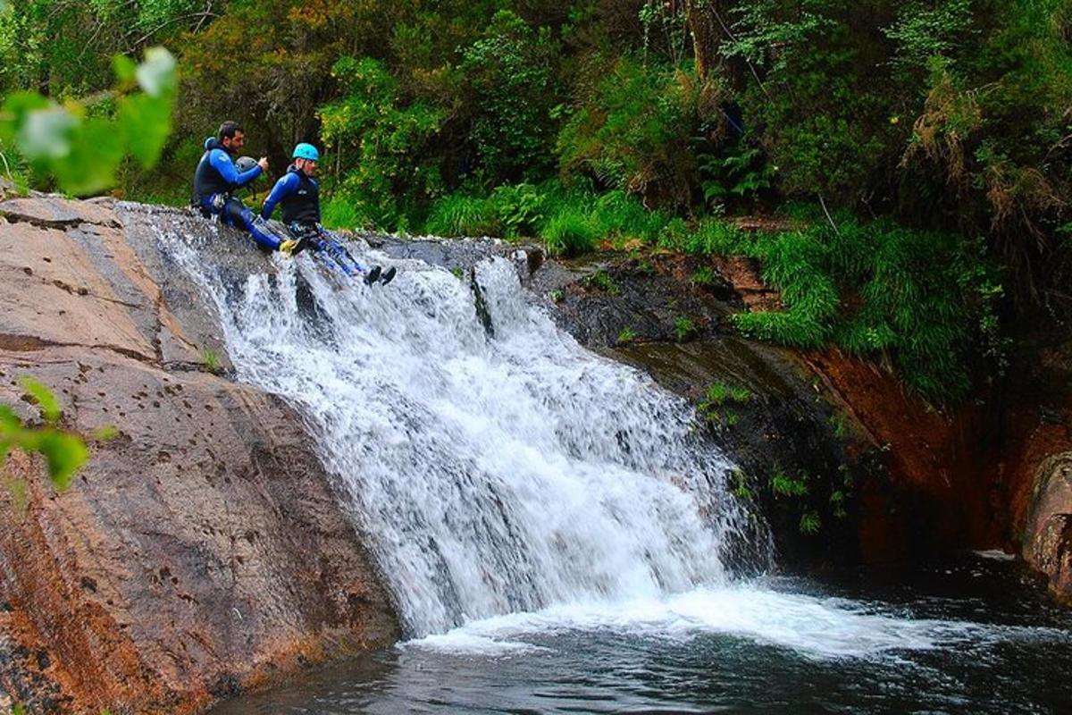 two people riding bikes on a waterfall