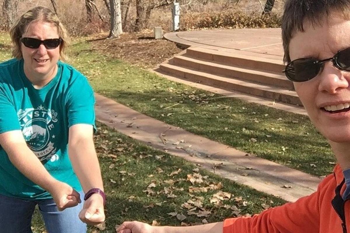 a man and a woman standing in a park