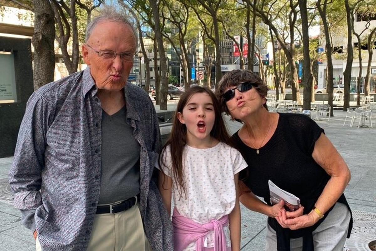 a man and woman standing next to a little girl