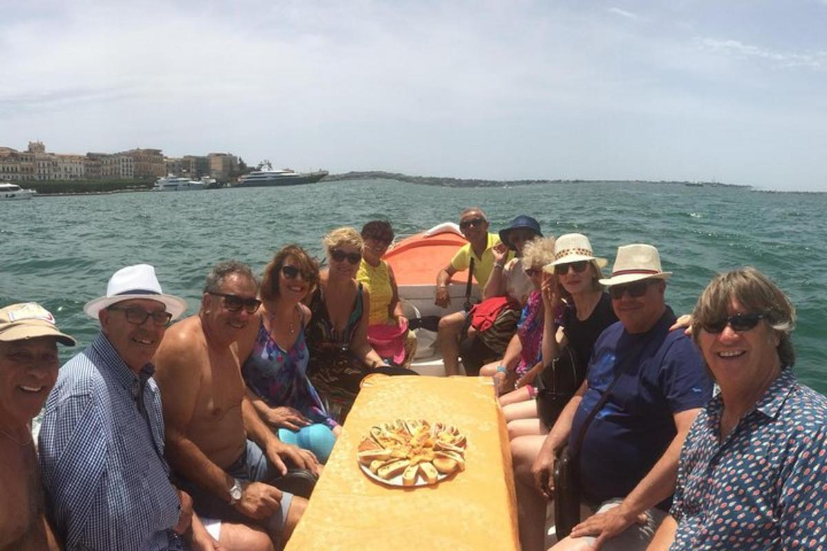 a group of people on a boat in the water