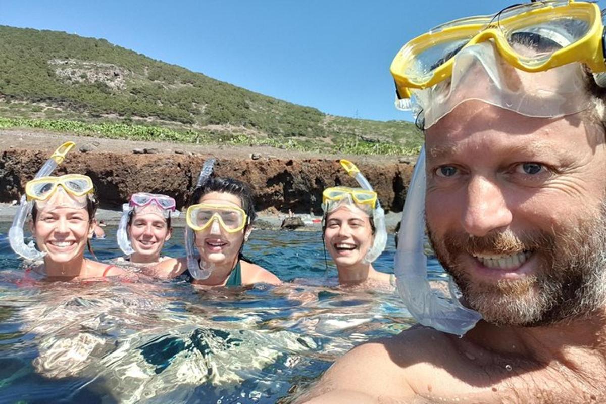a group of people in the water with goggles on their heads