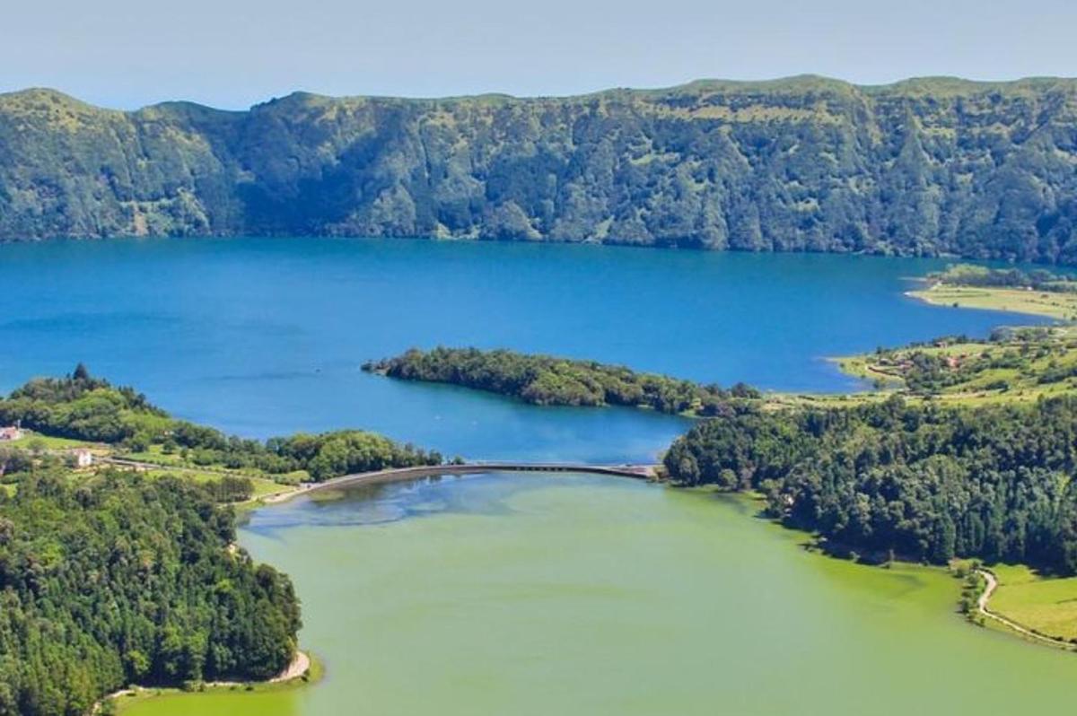 an aerial view of a large lake with trees