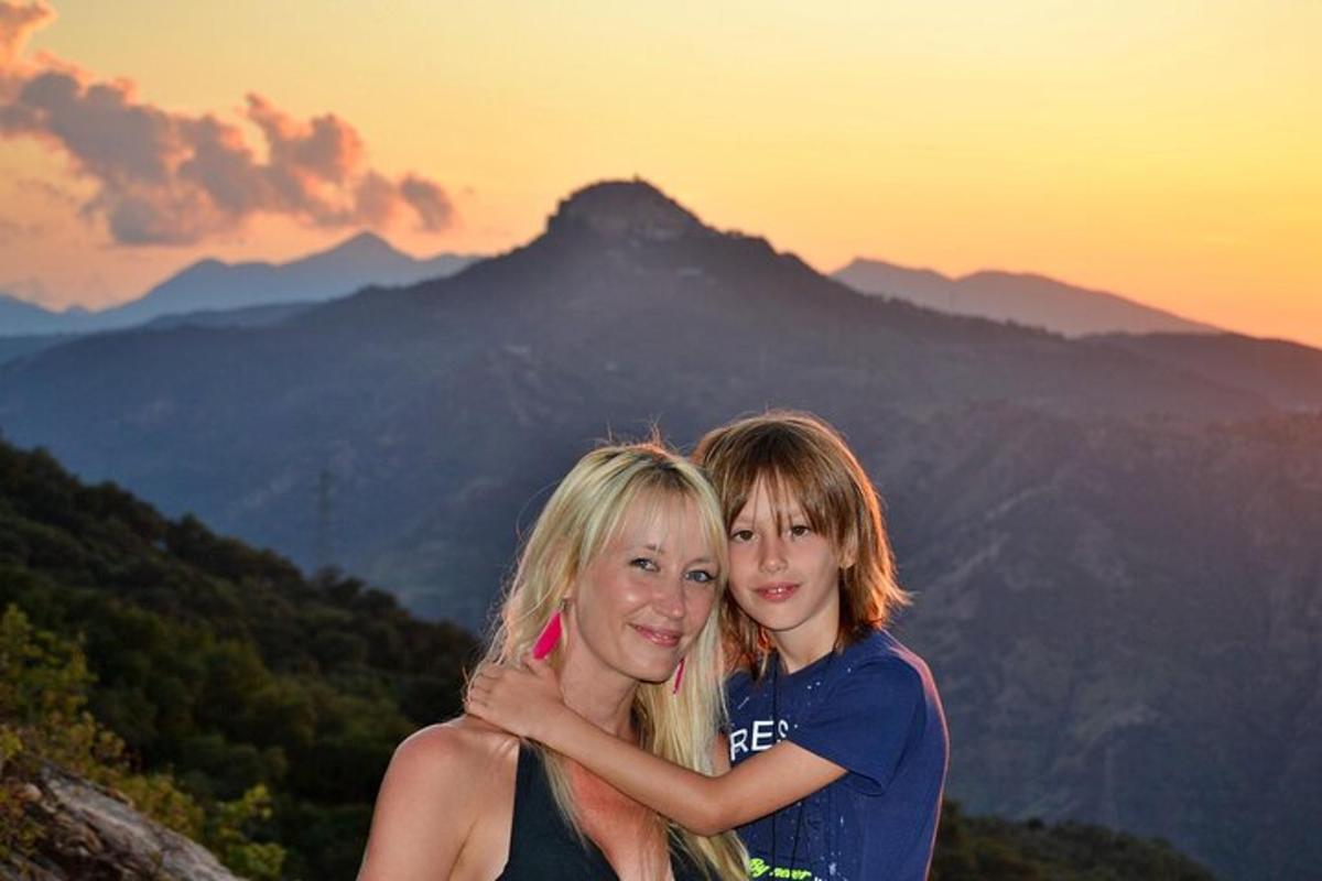 two women standing on top of a mountain