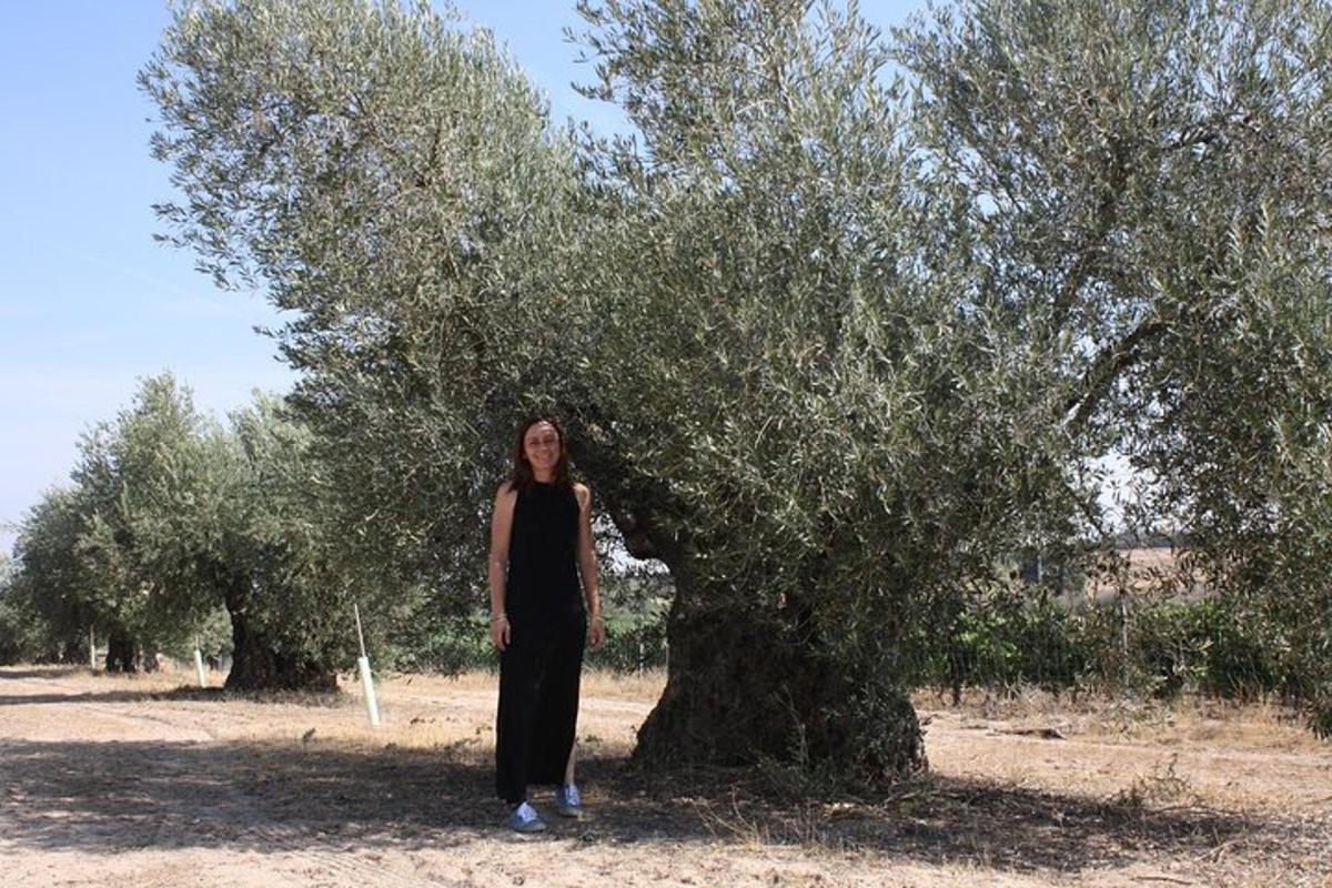 a woman standing in front of a tree