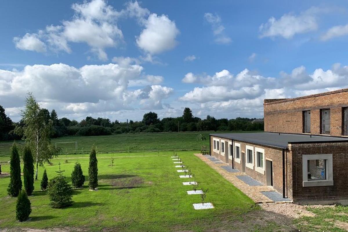 a brick building in a field next to a building