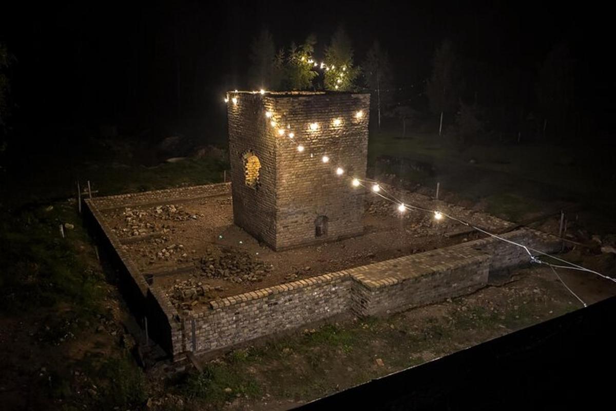 a stone tower with lights on it at night