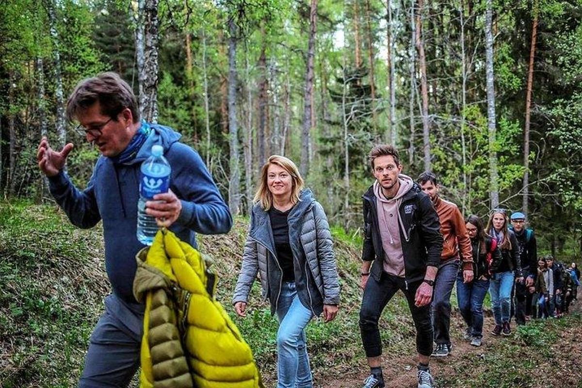 a group of people walking in the woods