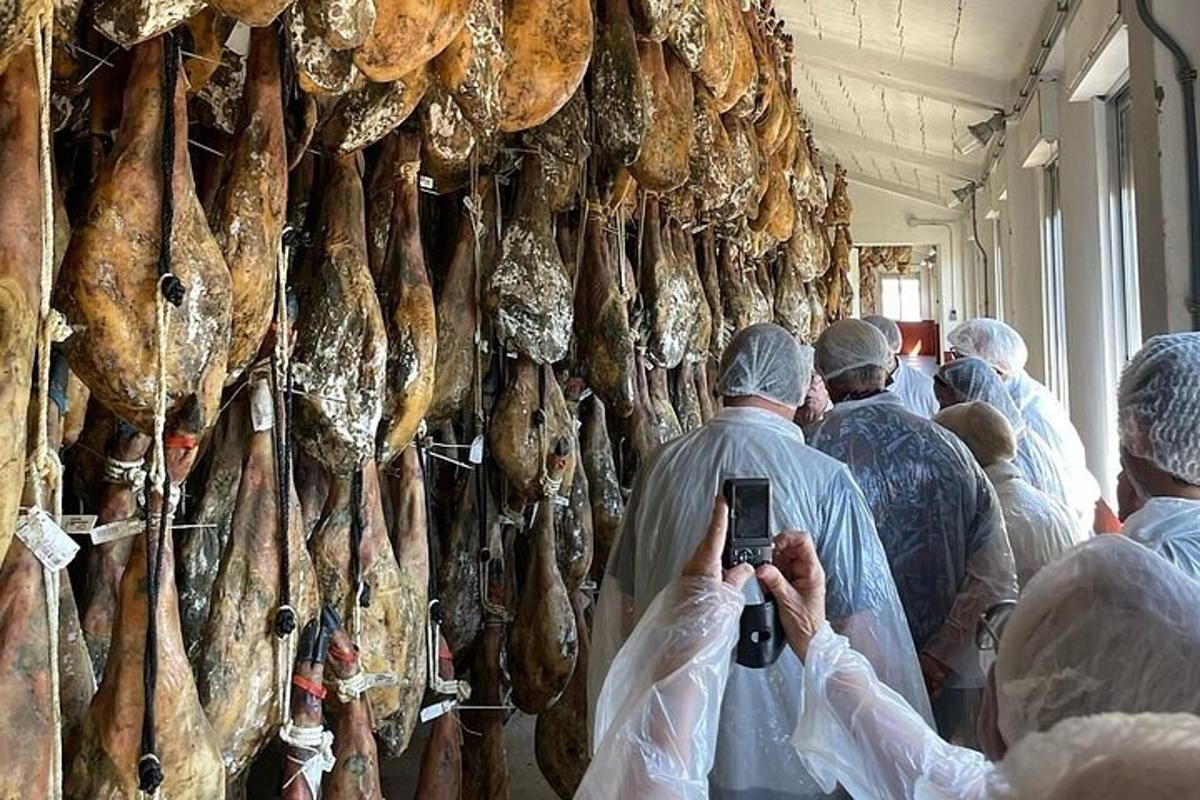 a group of people taking pictures of a wall of meat
