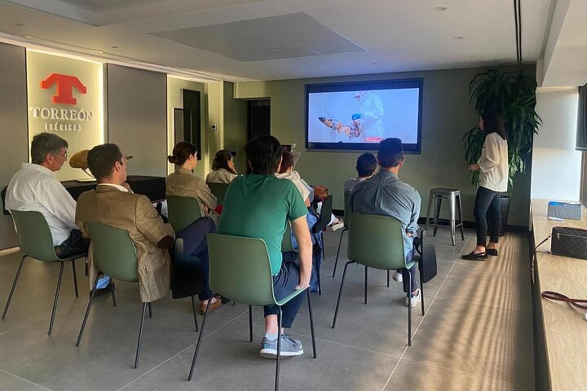 a group of people sitting in chairs watching a presentation