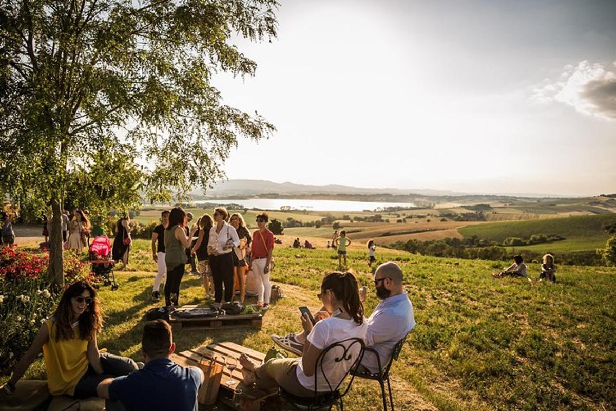 a group of people sitting in the grass in a field