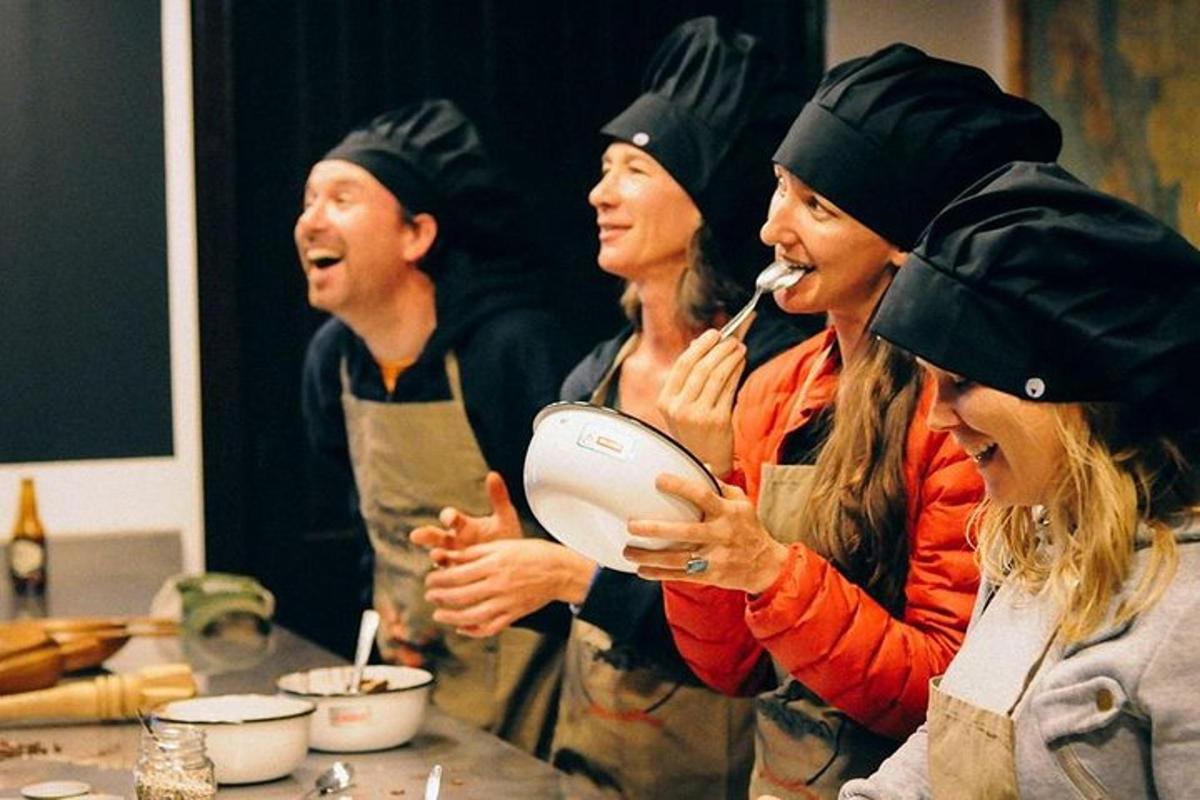 a group of people wearing aprons in a kitchen