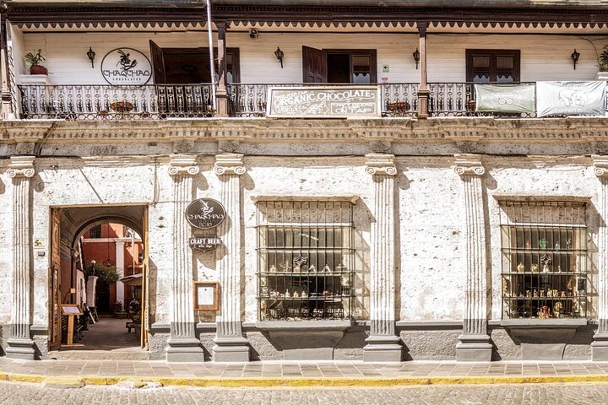 a white building with a balcony and a store