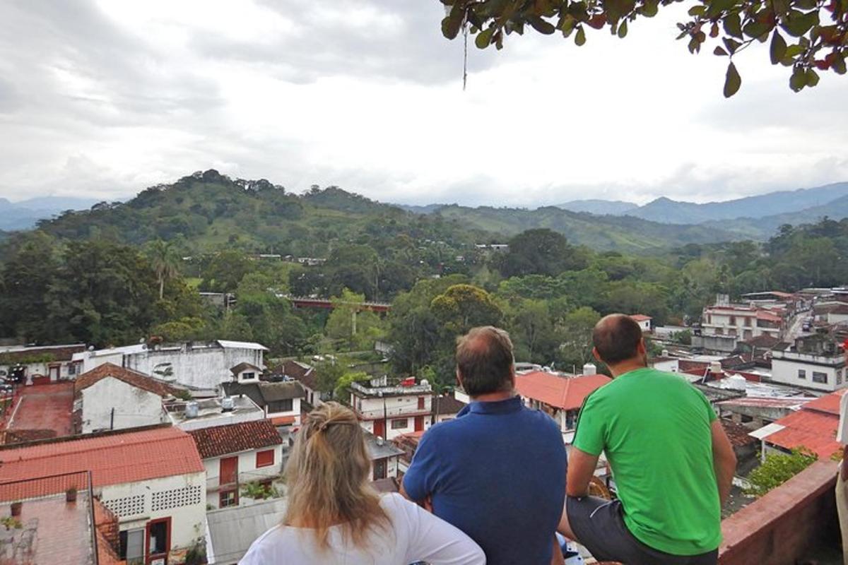 a group of three people sitting on top of a building