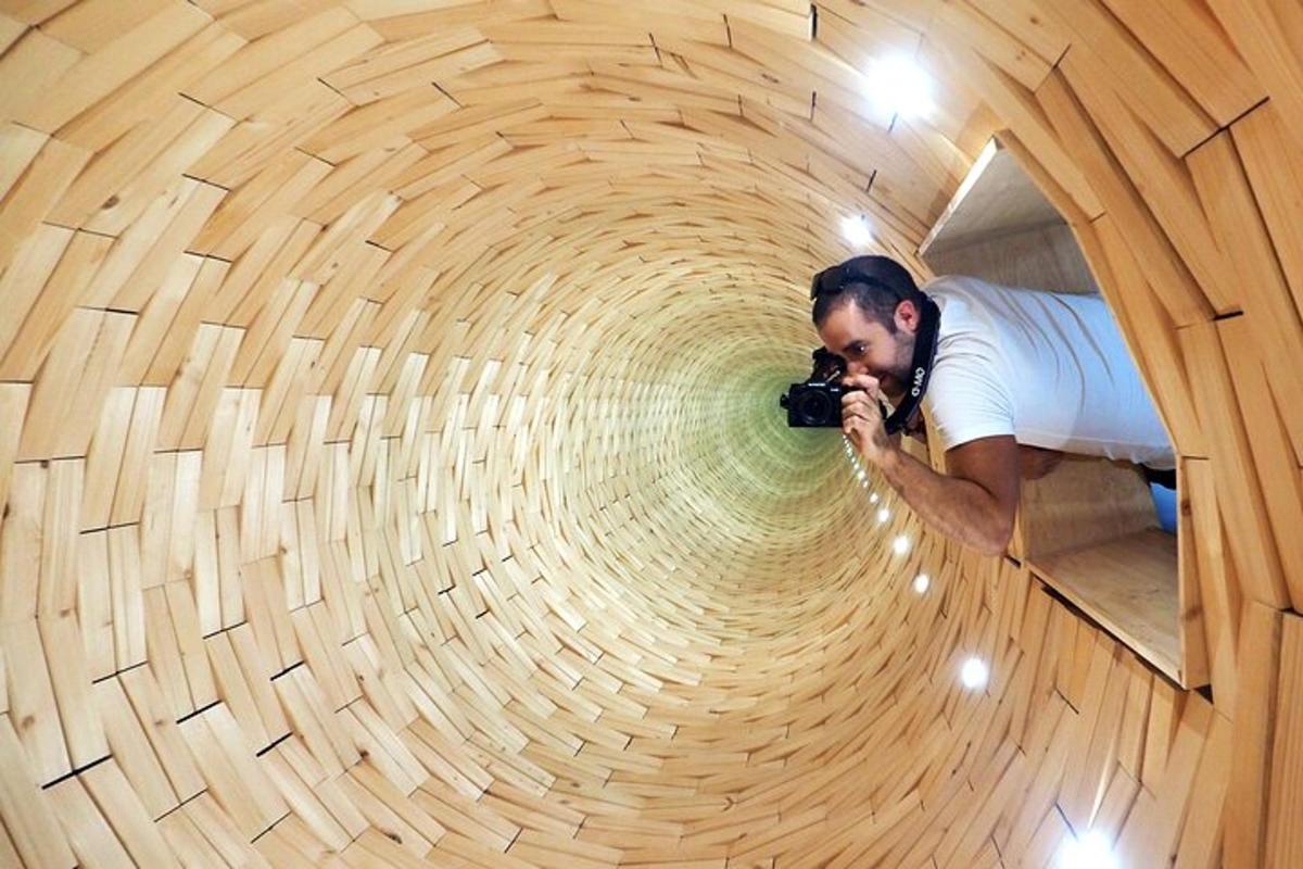 a man taking a picture of a tunnel with a camera