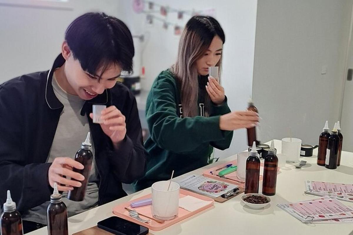 two people sitting at a table looking at their cell phones