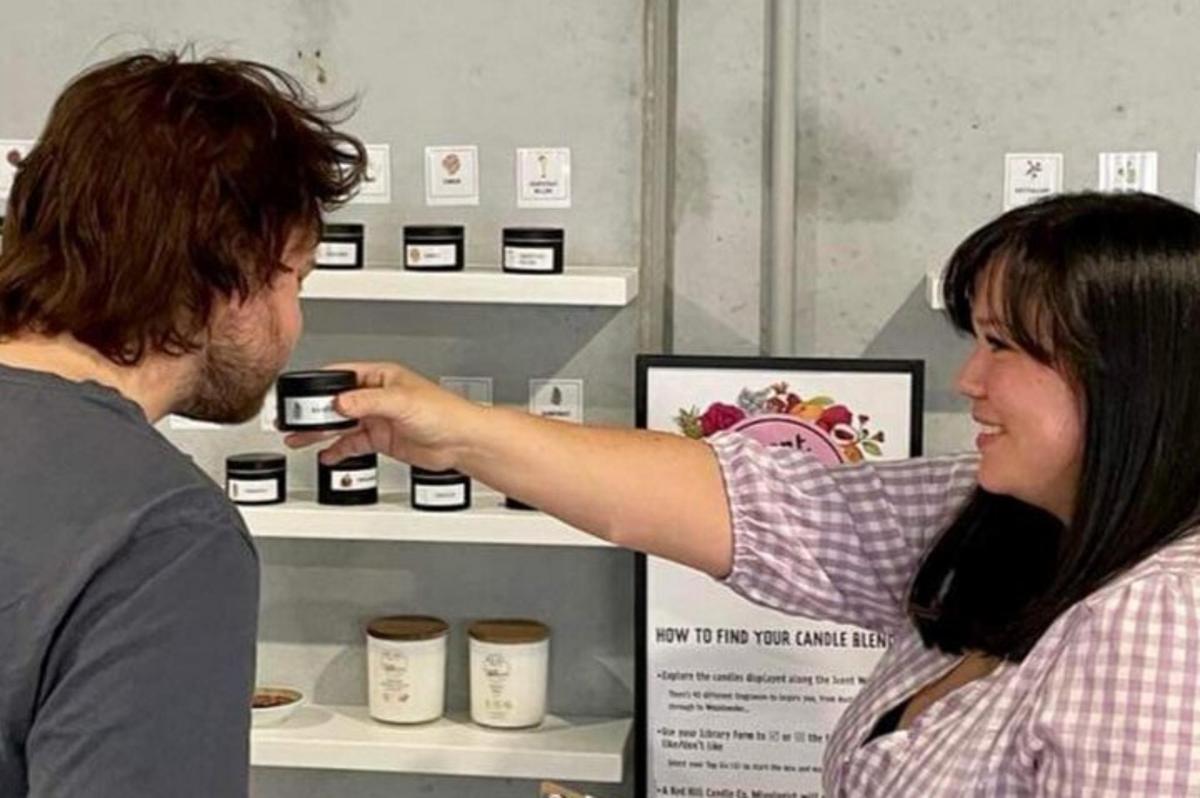 a woman taking a picture of a man at a store