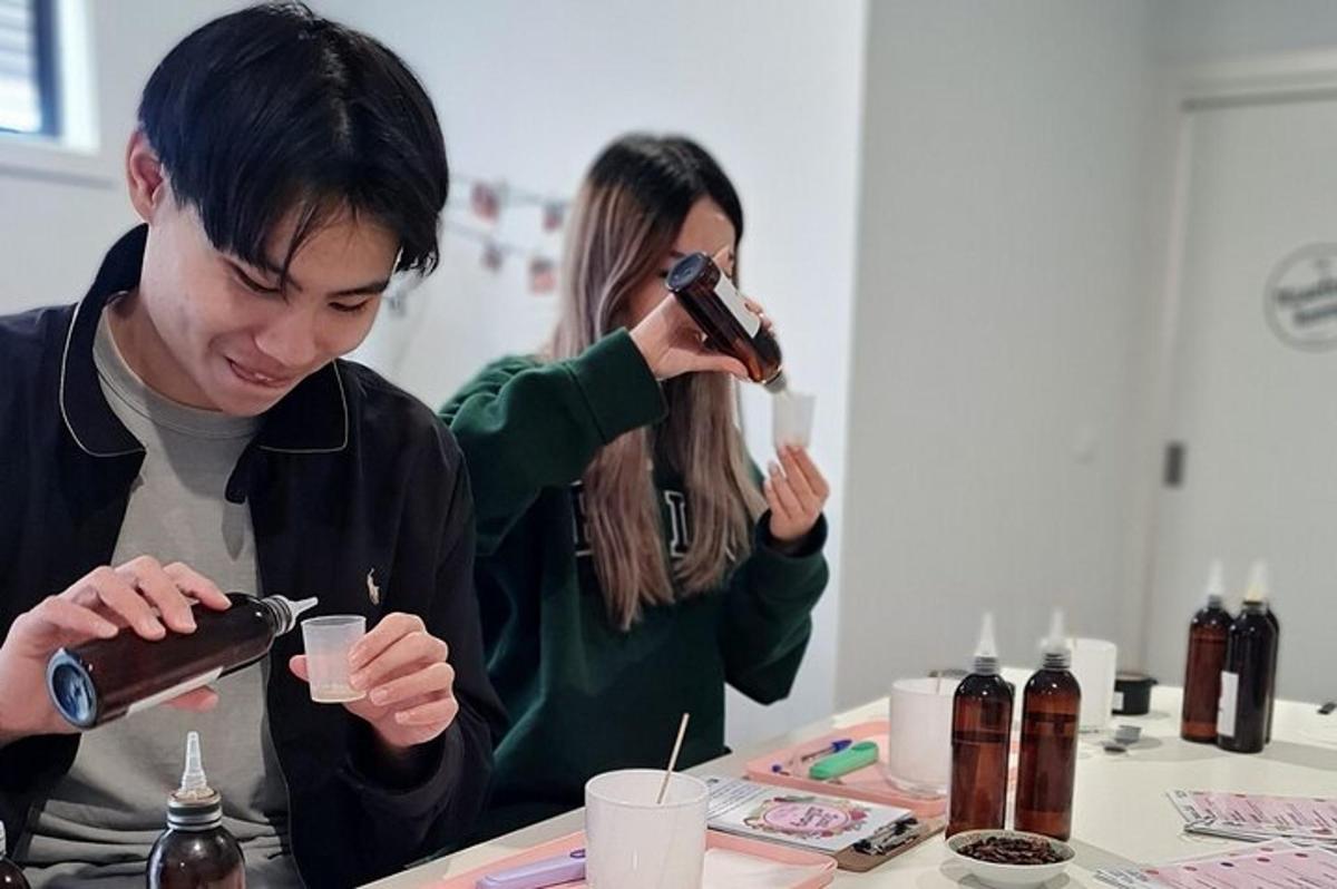 a man and a woman pouring a drink into a cup