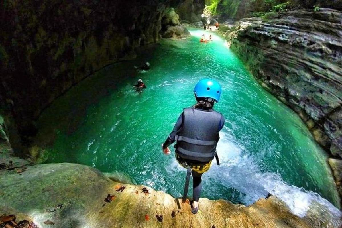 a person standing on a rock in a river