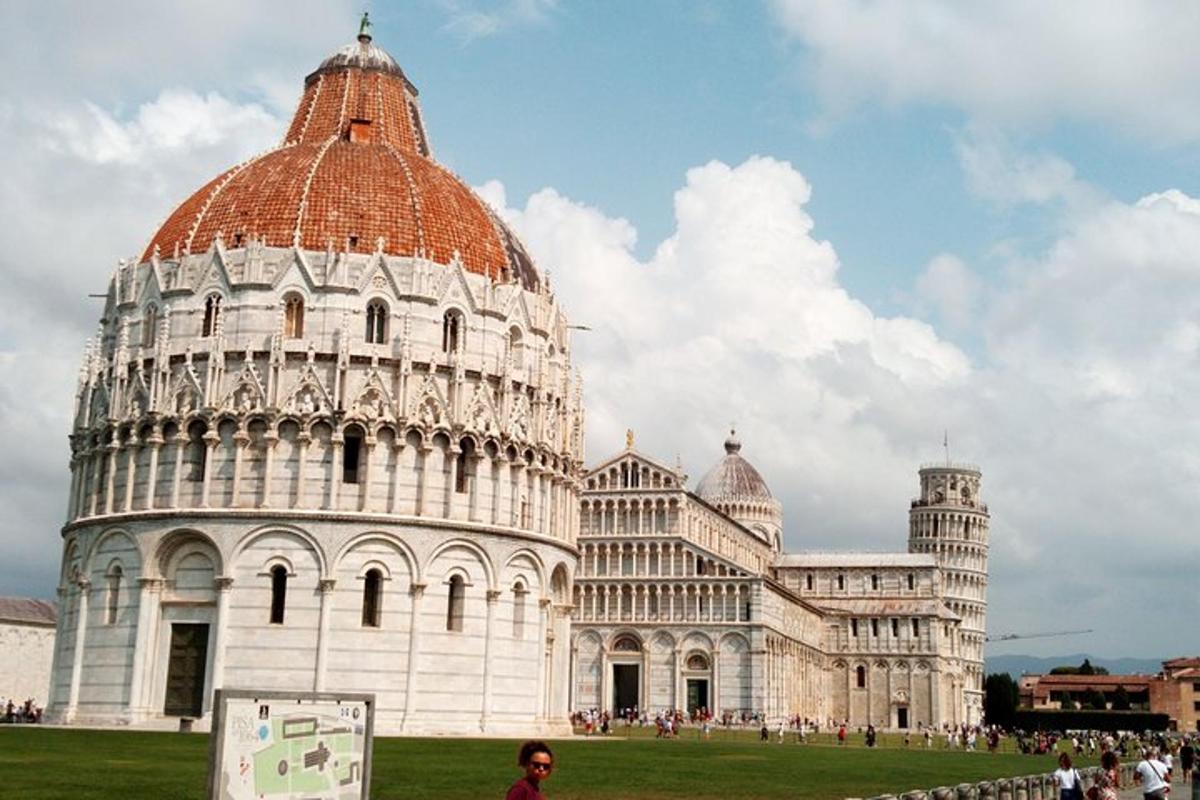 a woman standing in front of the leaning tower