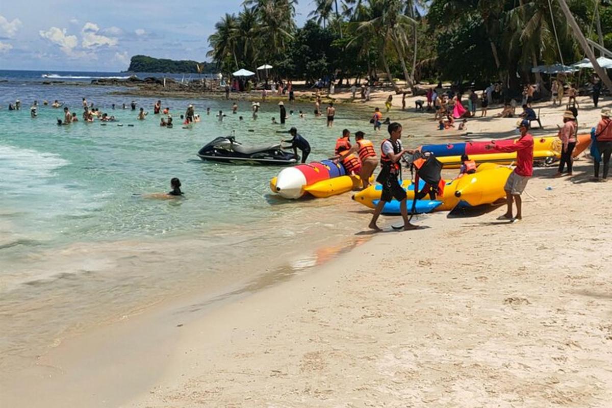 a group of people in the water at a beach