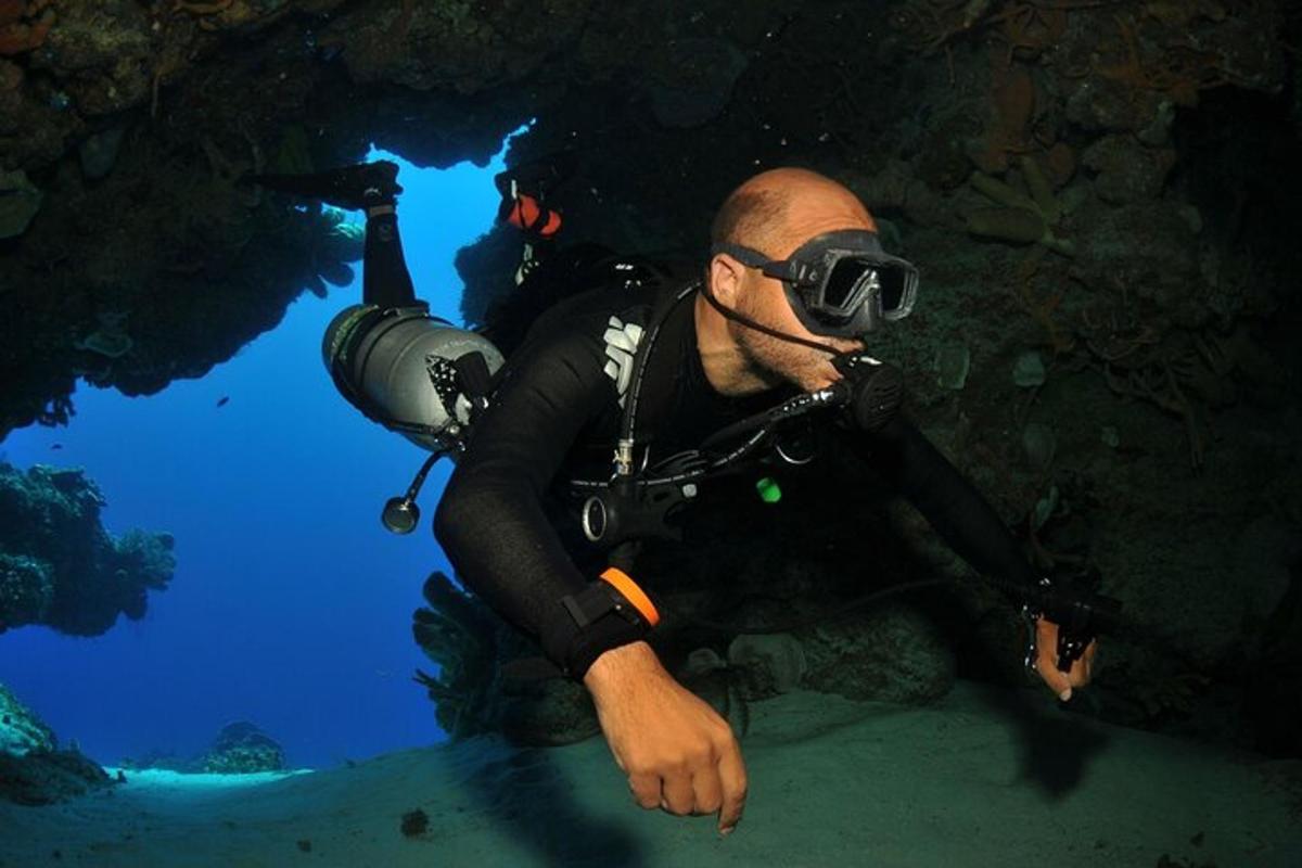 a diver with a camera in a cave