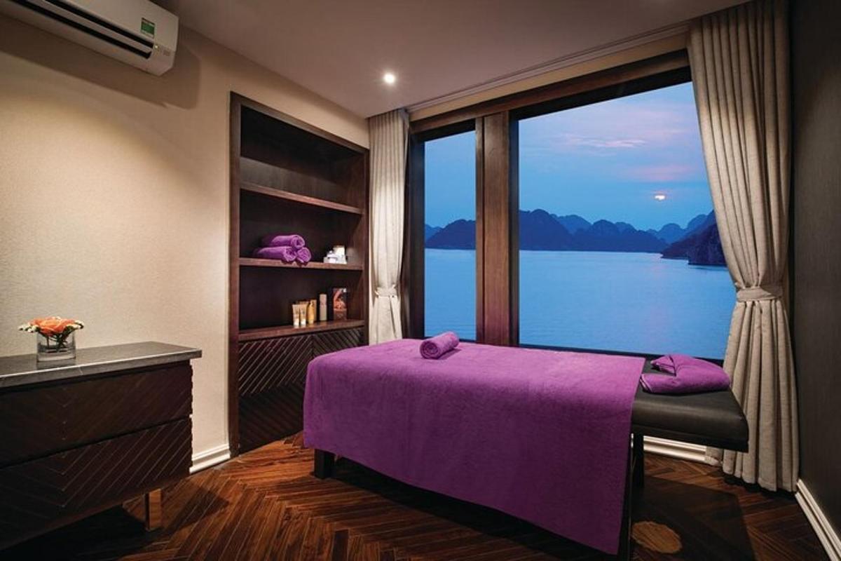 a bedroom with a purple bed and a large window