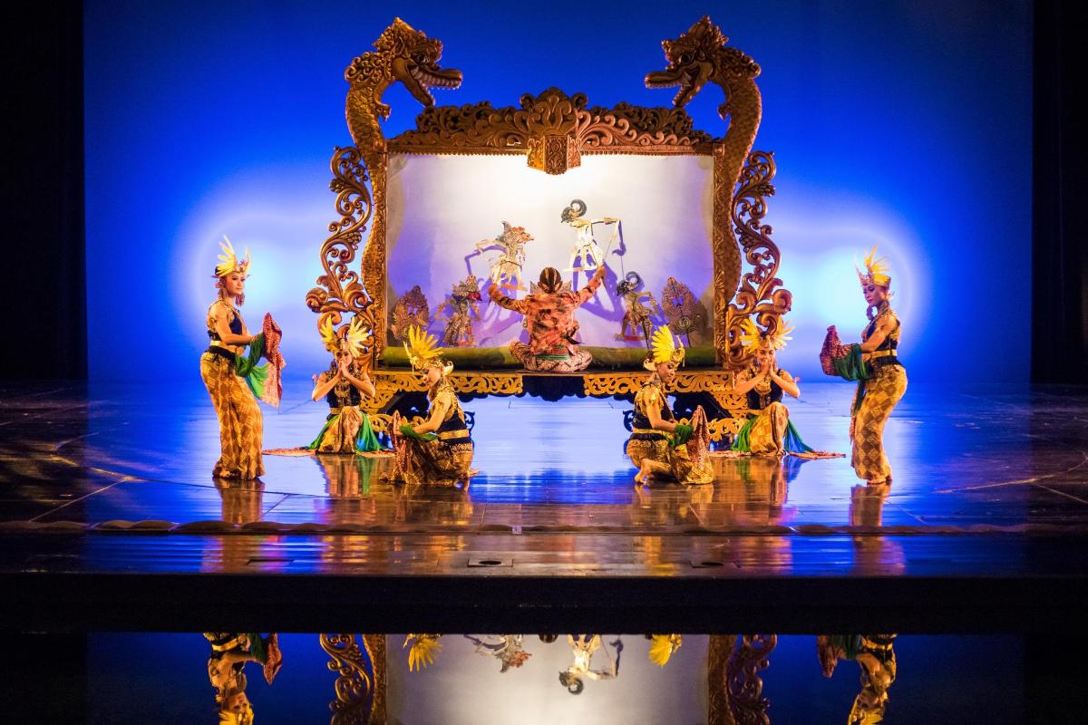 a group of figurines on a stage with a mirror