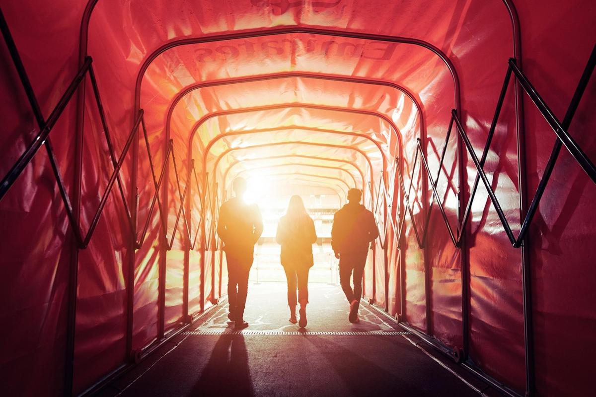 a group of people walking through a tunnel