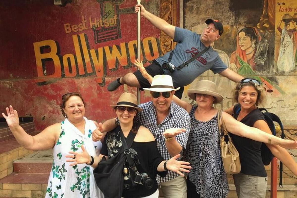a group of people posing for a picture in front of a building