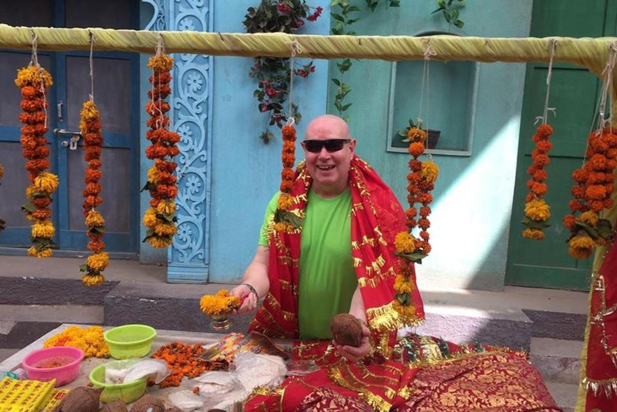 a man sitting in front of a table with flowers