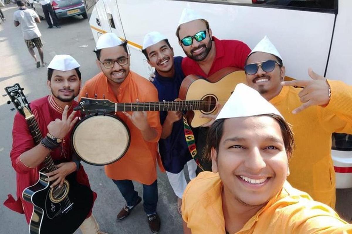 a group of men dressed in costumes posing for a picture