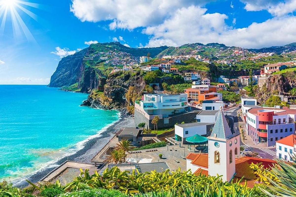 a view of a town next to the ocean