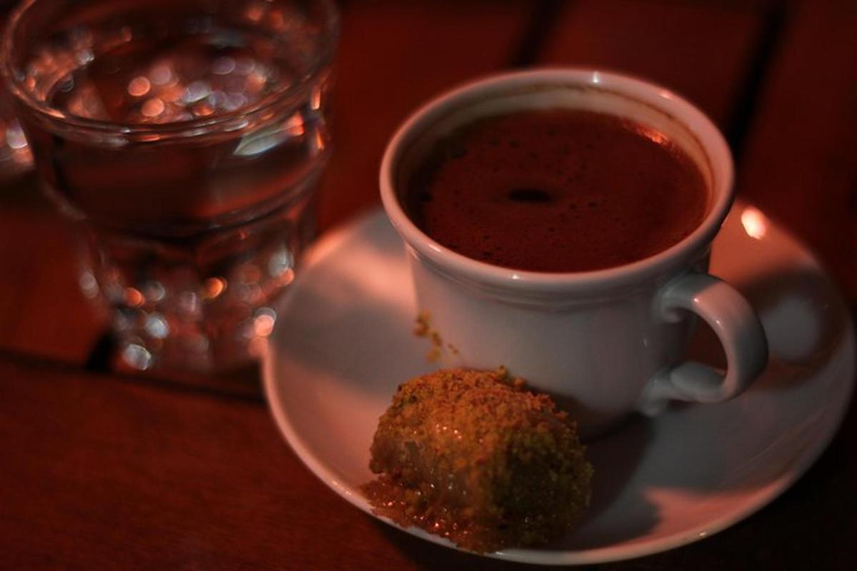 a cup of coffee and a piece of food on a plate