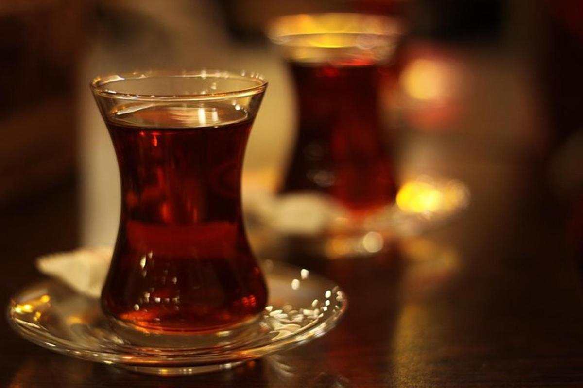 a glass cup on a plate on a table