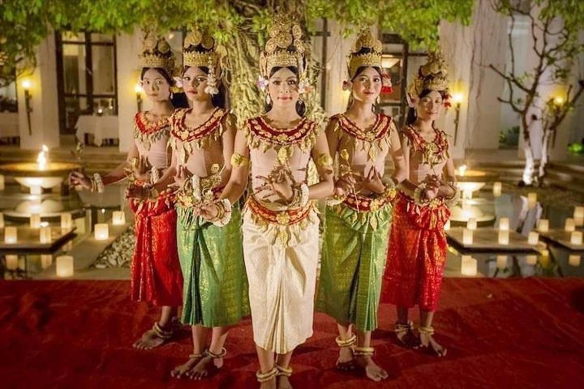 a group of women dressed in traditional clothing posing for a picture