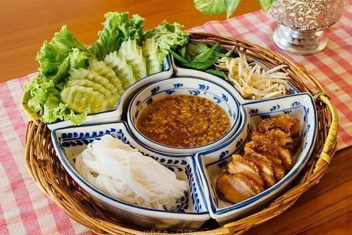 a basket of food with meat and vegetables on a table