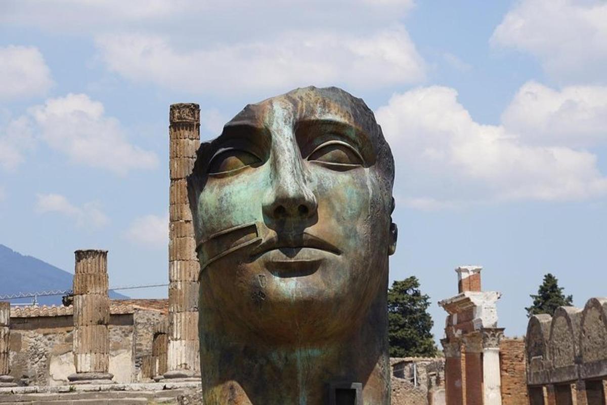 a statue of a face in front of a building