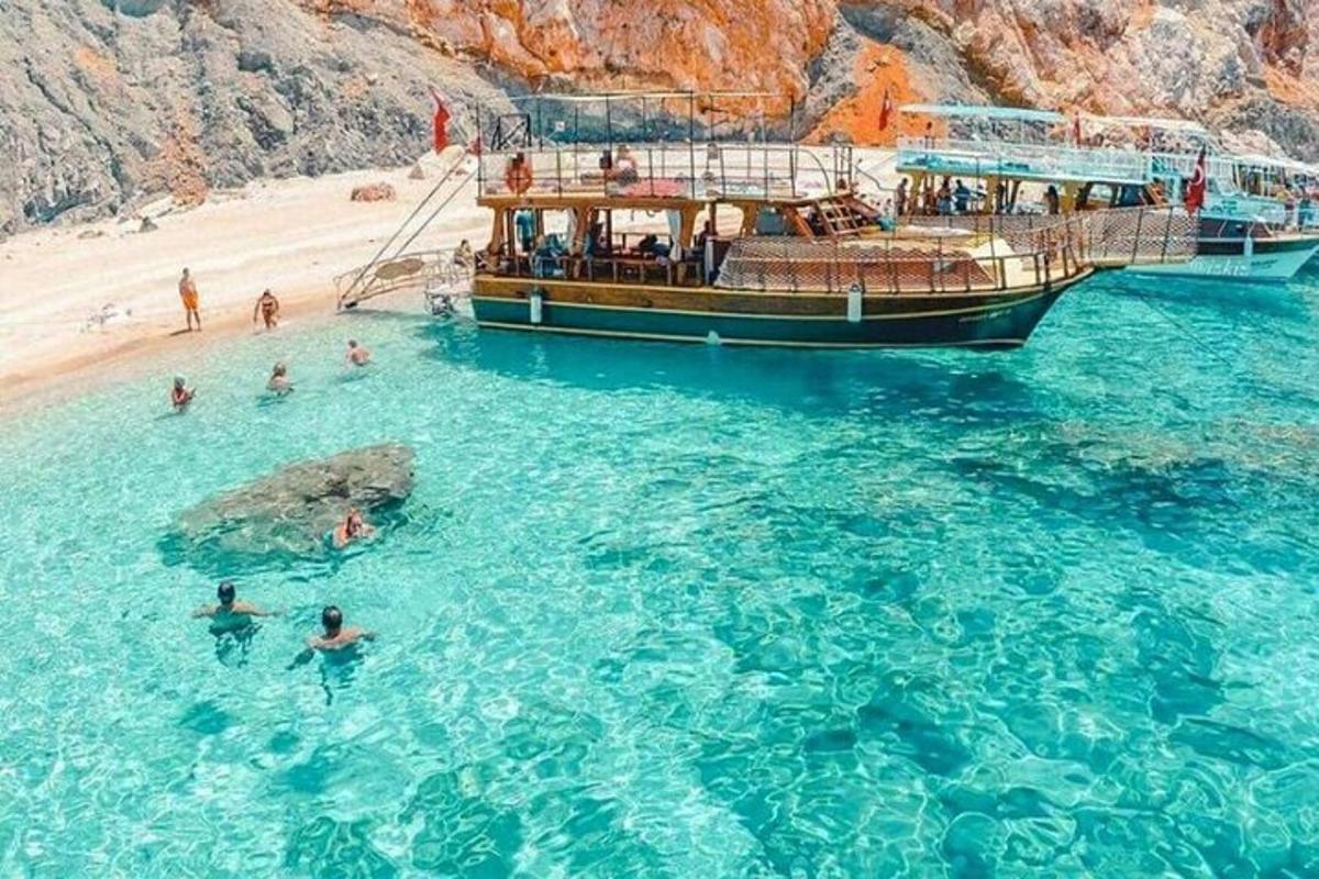a boat in the water next to a beach