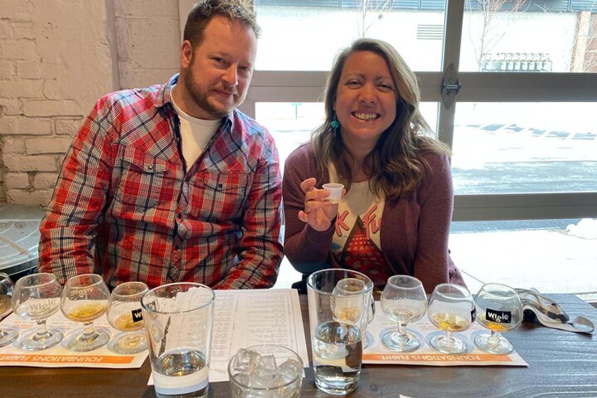 a man and woman sitting at a table with wine glasses